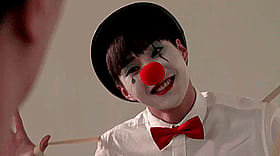 Crazy Clown Smiling at Camera with Red Nose'