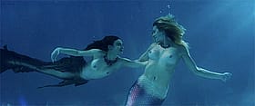 Two Naked Women Swimming in the Ocean'