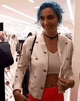 Sultry blue-haired vixen flaunts her curves'