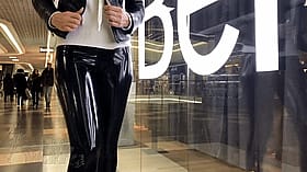 Bombshell strutting in shiny latex leggings'