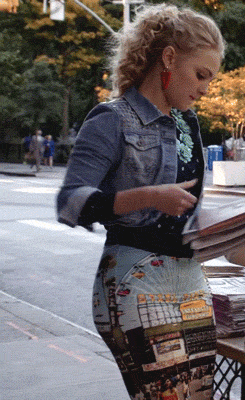 Saucy minx teasing in a snug skirt while grabbing the paper picture 1 of 1