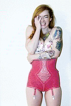 Fiery redhead in sexy scarlet lingerie teases with tattooed curves'