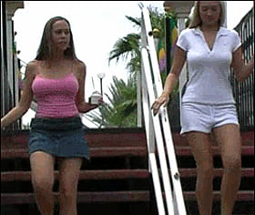 Two hot chicks walking up stairs'