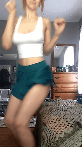 Redhead Teen in a Skirt Shakes Her Pussy'